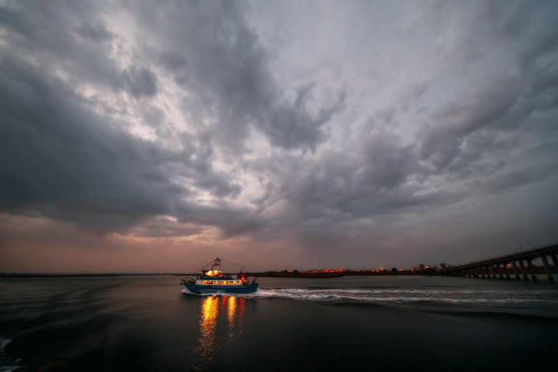 Boat at night under cloudy sky
